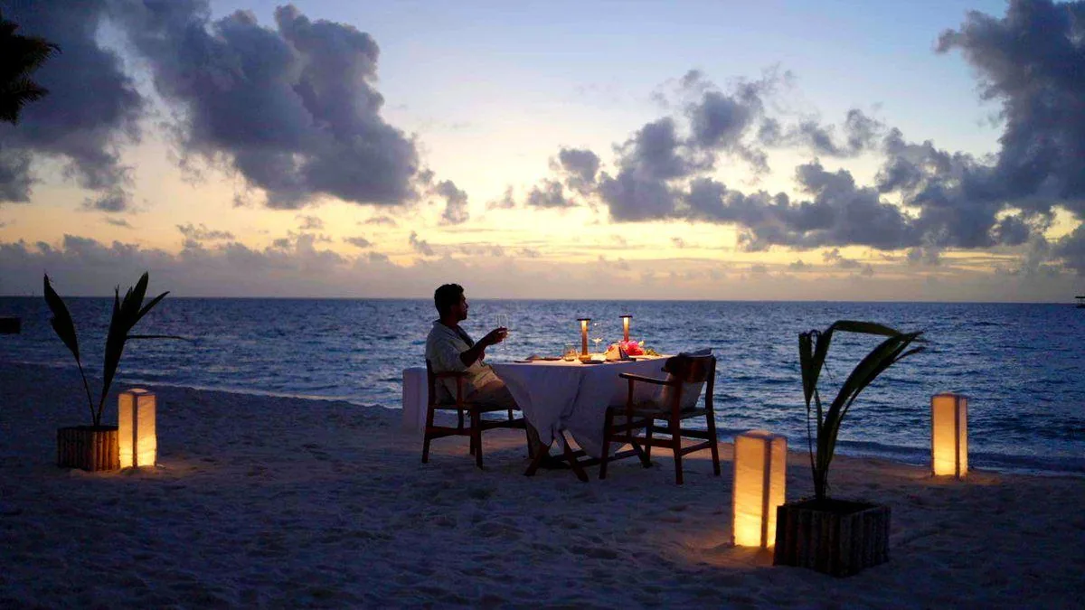 A single table on the sand at dusk