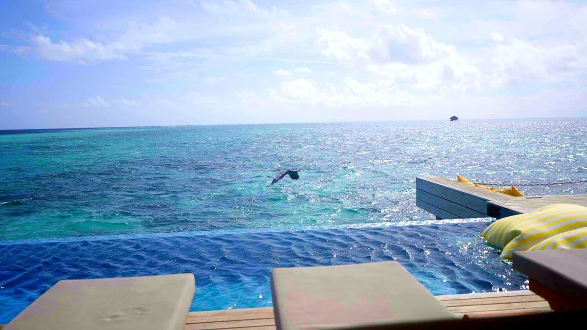 Swimming out past the villa pool into the lagoon