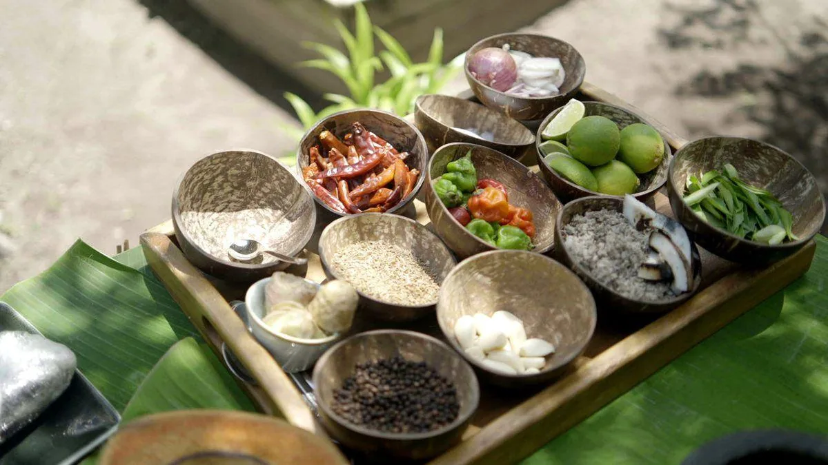 Spice and aromatics laid out in coconut bowls
