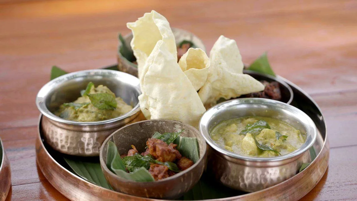 Curries, sambol and papadum in steel