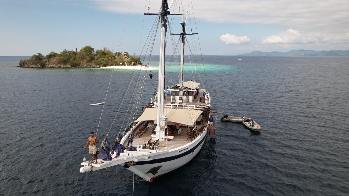 A hand-built phinisi at anchor in Komodo National Park, Indonesia