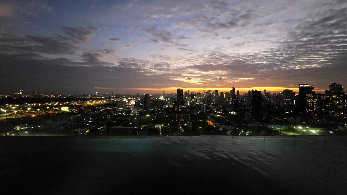 Rooftop pool, the city going over to dusk