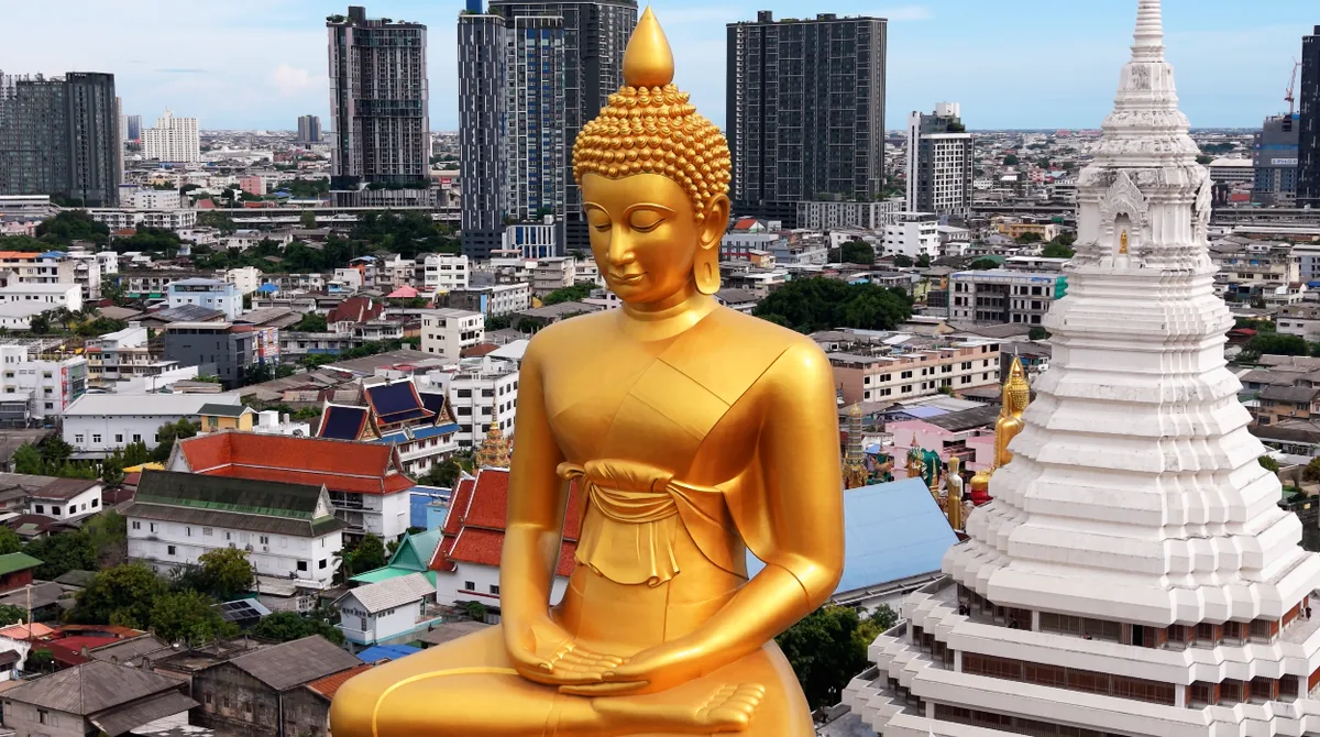 The seated Buddha at Wat Paknam, above the low rooftops
