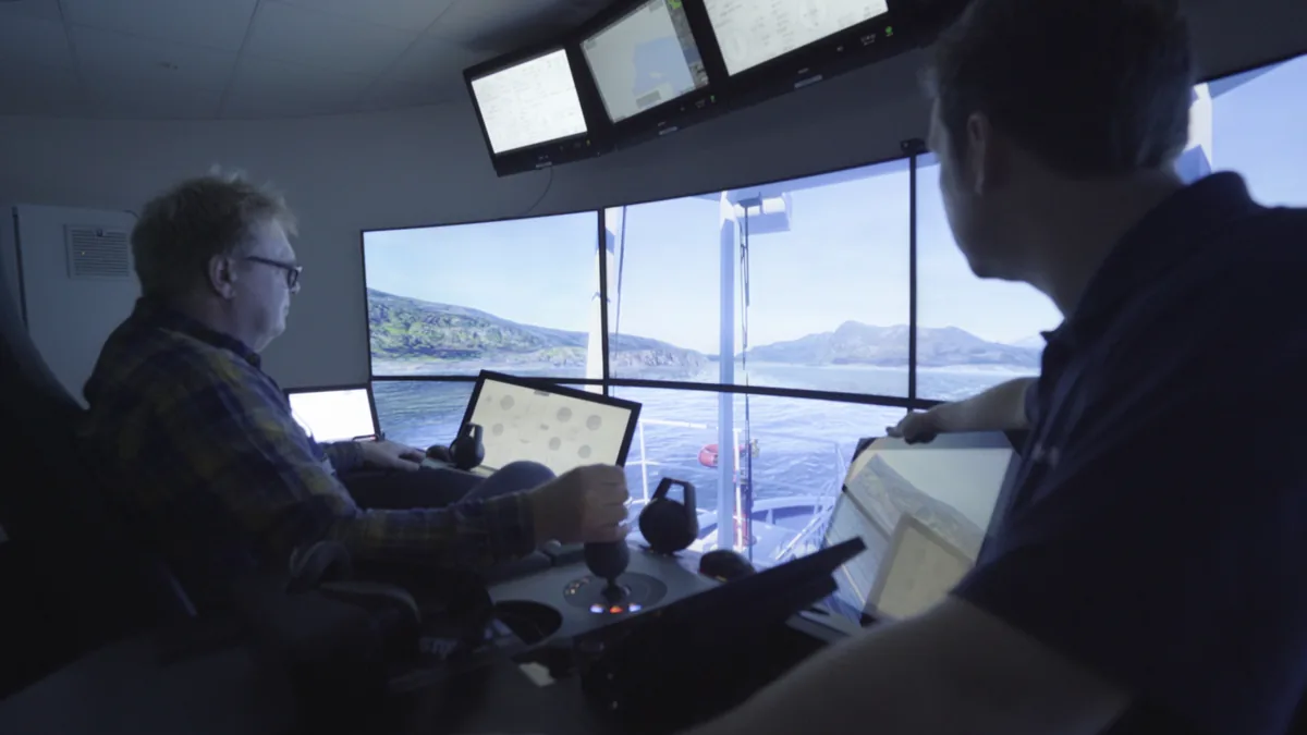 Two engineers running a manoeuvre in the bridge simulator